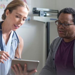 Doctor with patient showing information on a tablet