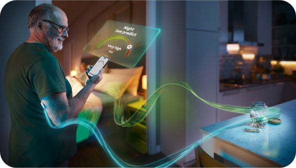 Image show person holding the Accu-Chek SmartGuide Predict app at home using the Night Time Predict feature
