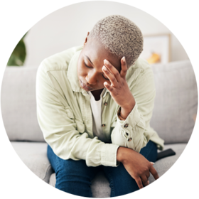 Person sat on sofa with hand supporting their head