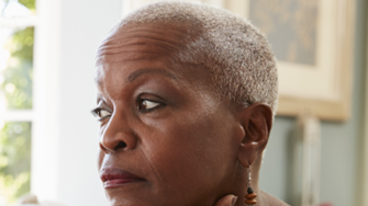 Lady sitting down looking to the side deep in thought