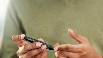 Person checking their blood glucose levels using a finger pricker