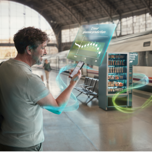 Man using the Accu-Chek SmartGuide CGM solution with the Predict app