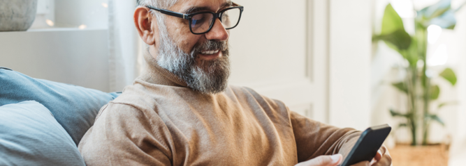 Man looking at phone and smiling