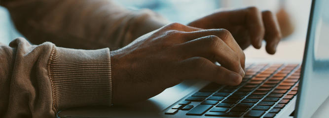 Typing on a laptop