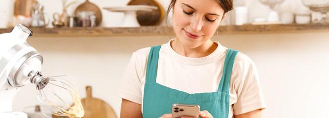 Lady using phone in the kitchen