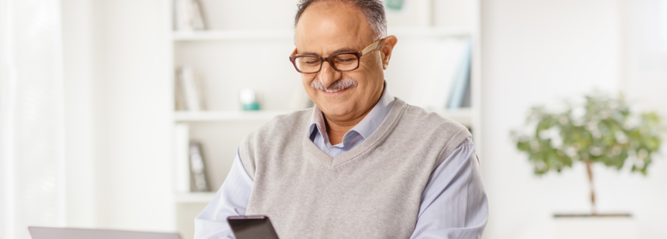 Man looking at phone and smiling