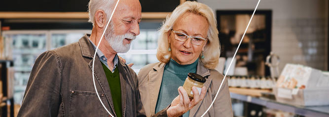 A couple reading the ingredient list of a product at a grocery store 