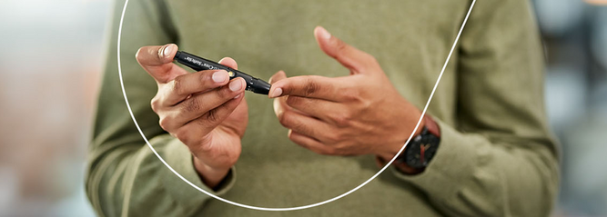 Person checking their blood glucose levels using a finger pricker